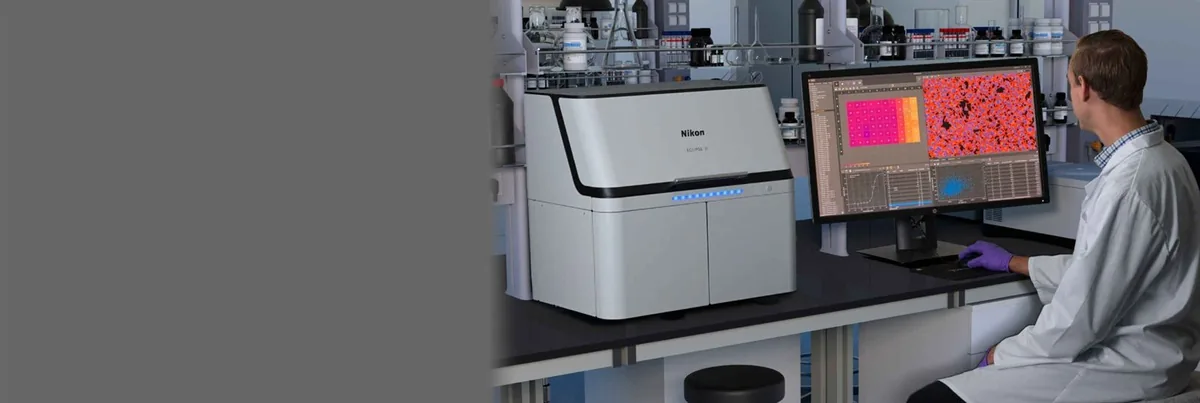 Scientist using a Nikon microscope in a laboratory